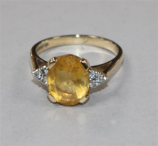 A 9ct gold, citrine and diamond set dress ring, size N.